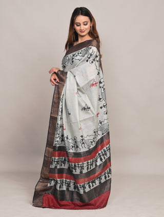 Model wearing Kosakari Chitralekha ivory blended Kosa silk hand block printed saree with tribal motifs and earthy contrast border.