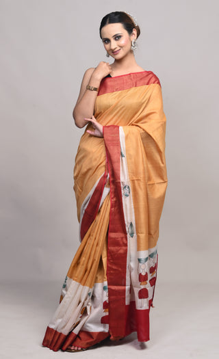 Model wearing Kosakari Rangbhoomi mustard blended Kosa silk hand block printed saree with tribal motifs and red border.