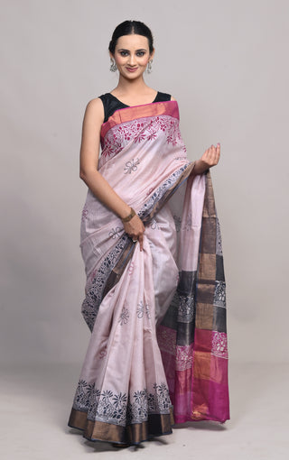 Model wearing Kosakari Pushpika blush pink blended Kosa silk hand block printed saree with floral motifs and contrast pallu.