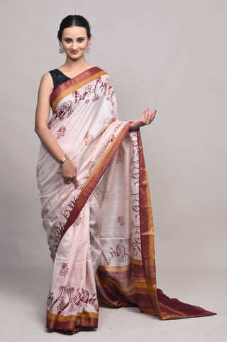 Model wearing Kosakari Mriganka blush pink blended Kosa silk hand block printed saree with tribal motifs and multicolor border.