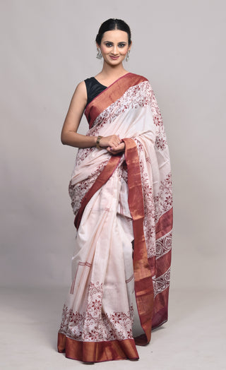 Model wearing Kosakari Kusumika ivory blended Kosa silk hand block printed saree with floral motifs and rust border.