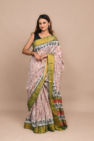 Model wearing Kosakari Vasundhara beige blended Kosa silk hand block printed saree with Bastar art motifs and green border.