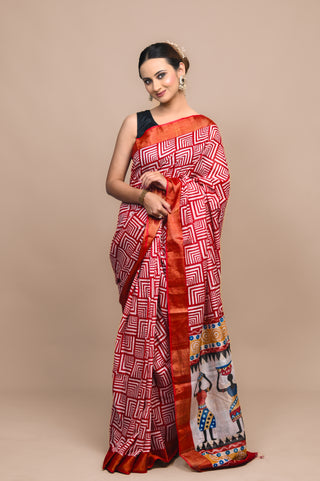 Model wearing Kosakari Nrityangana red blended Kosa silk hand block printed saree with tribal dance motifs and multicolor border.