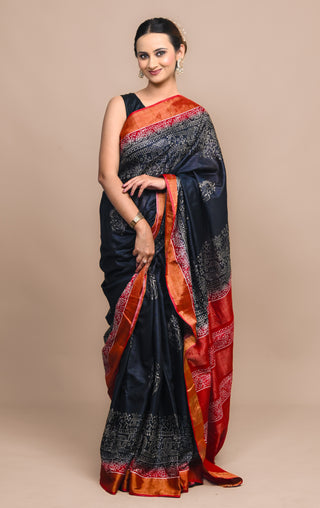 Model wearing Kosakari Gramika indigo blended Kosa silk hand block printed saree with tribal village motifs and red pallu.