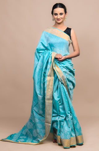 Model wearing Kosakari Taralika turquoise blended Kosa silk hand block printed saree with traditional motifs and golden border.